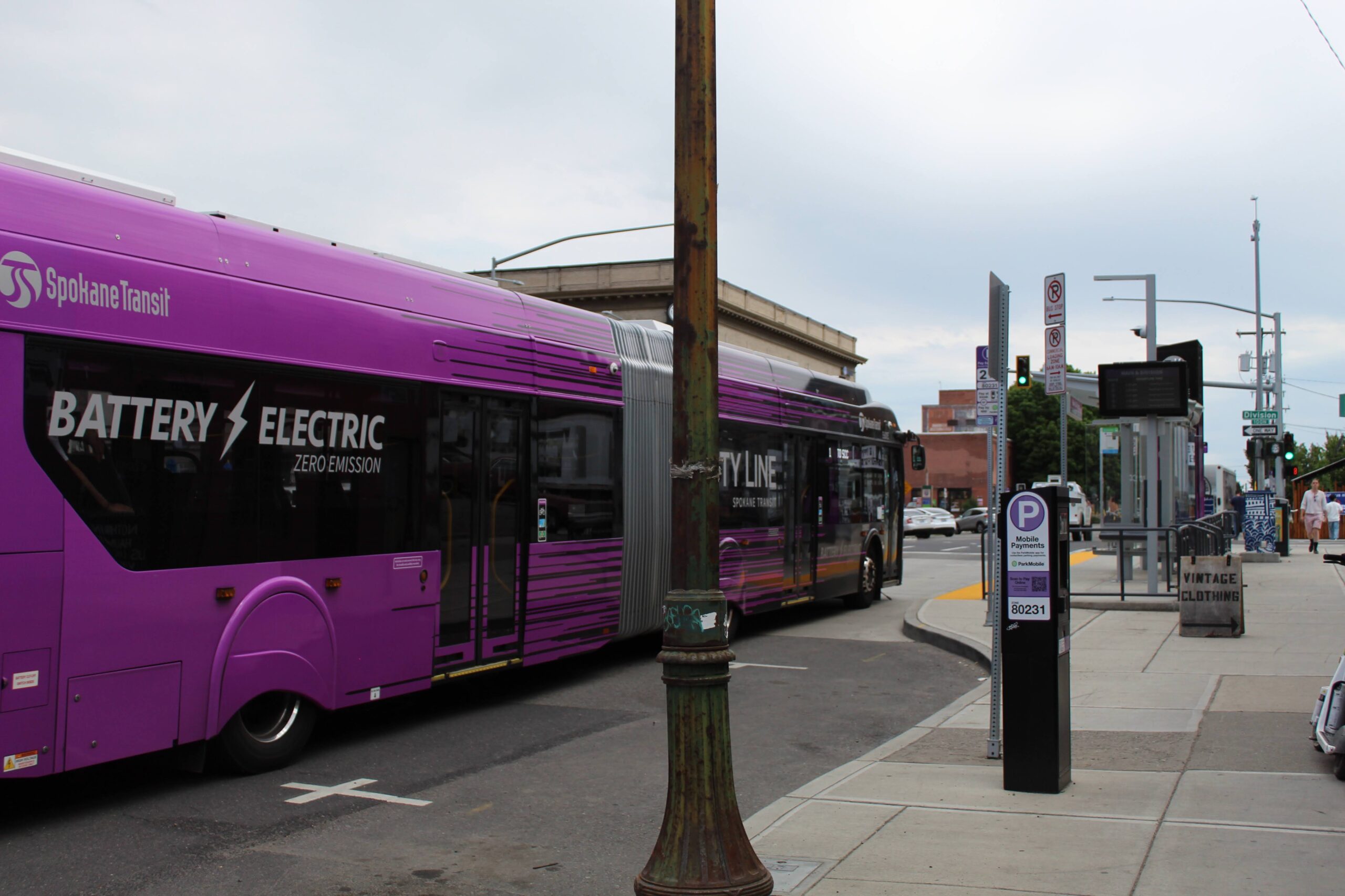 Pink CityLine bus pulls up to a bus stop in Spokane